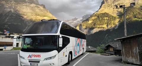 Coach surrounded by mountains in late-day light