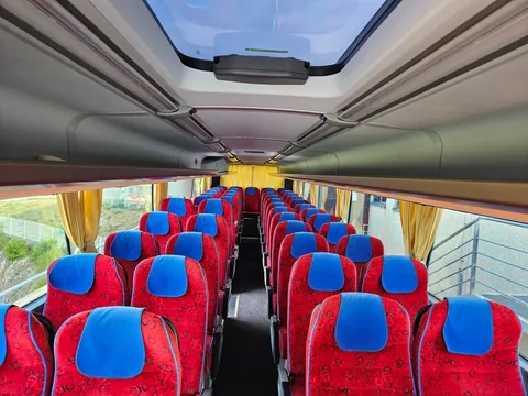 Red and blue seats along the coach aisle
