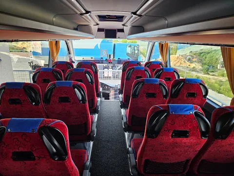 Red and blue passenger seats viewed towards the windscreen