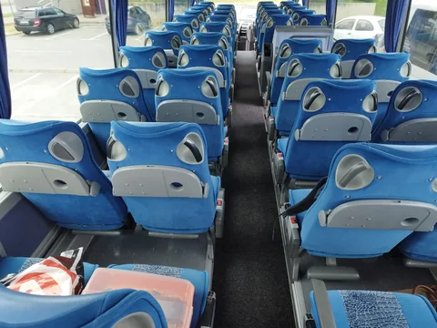 Blue passenger seats viewed from the front of the cabin