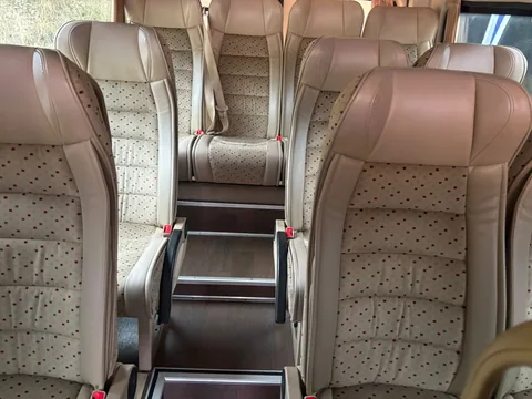 Beige coach seats and central aisle