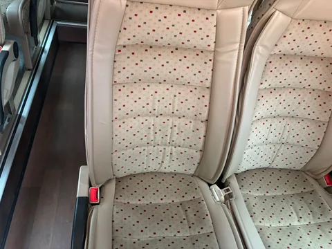 Close-up of beige seat upholstery and armrests